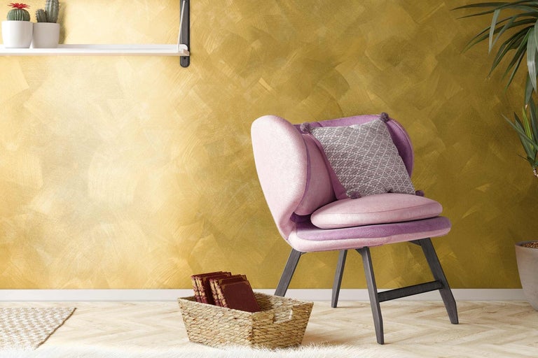 Obývací pokoj se zlatou stěnou, křeslem a dekoracemi