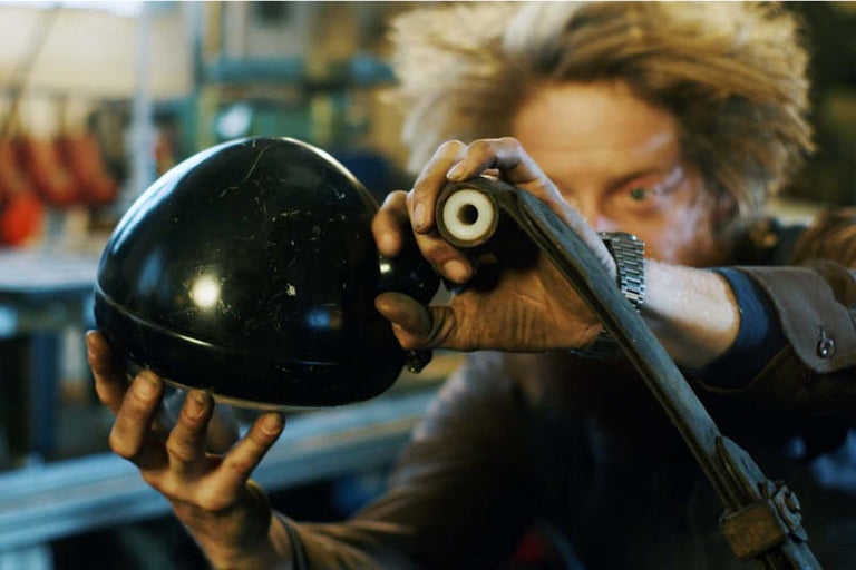 Muž drží v ruce lampu