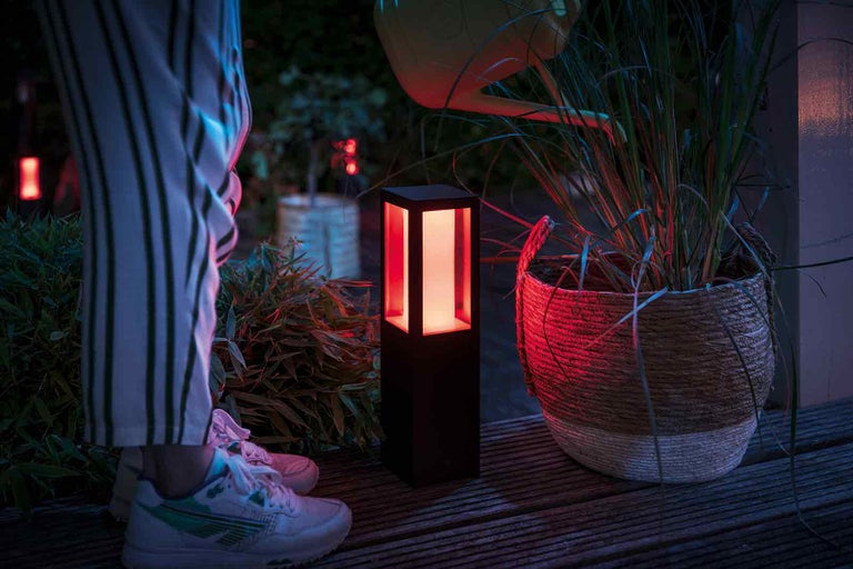 Dekorativní zahradní lampa vedle květináče venku