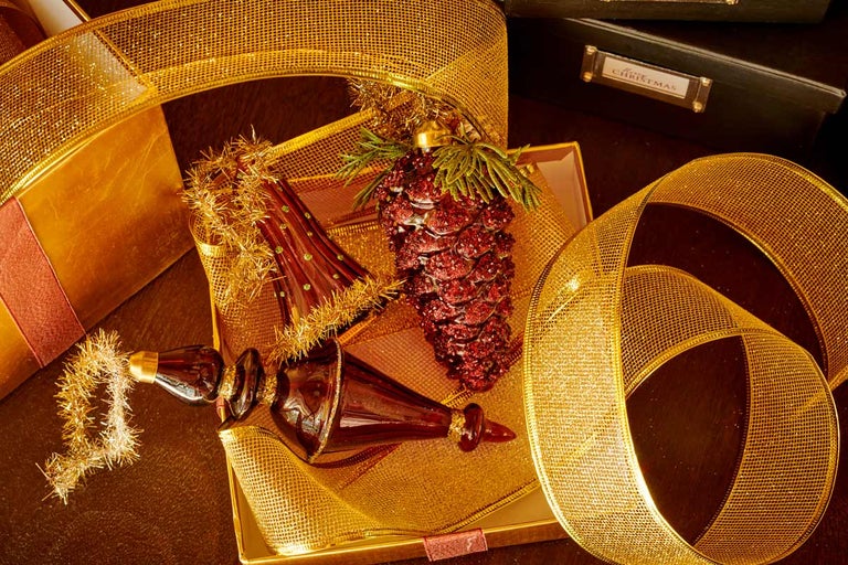 Slavnostní aranžmá s ozdobami na vánoční stromeček, dárky a mašlemi pro vánoční výzdobu