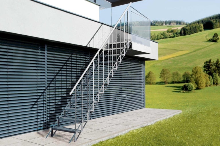 Kovové venkovní schodiště u moderního domu