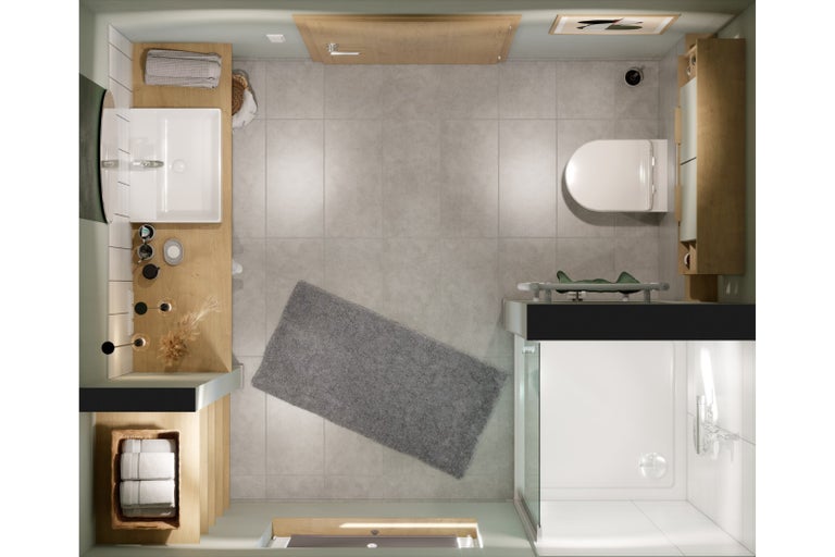 Pohled shora na koupelnu s umyvadlem, toaletou, sprchou a koupelnovou předložkou