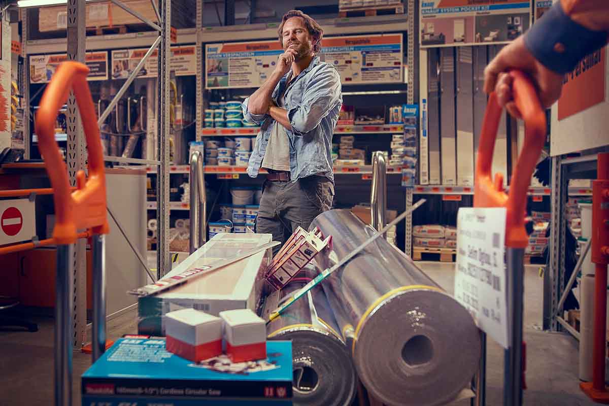 Zákazník s nákupním vozíkem plným stavebního materiálu v obchodě Hornbach.