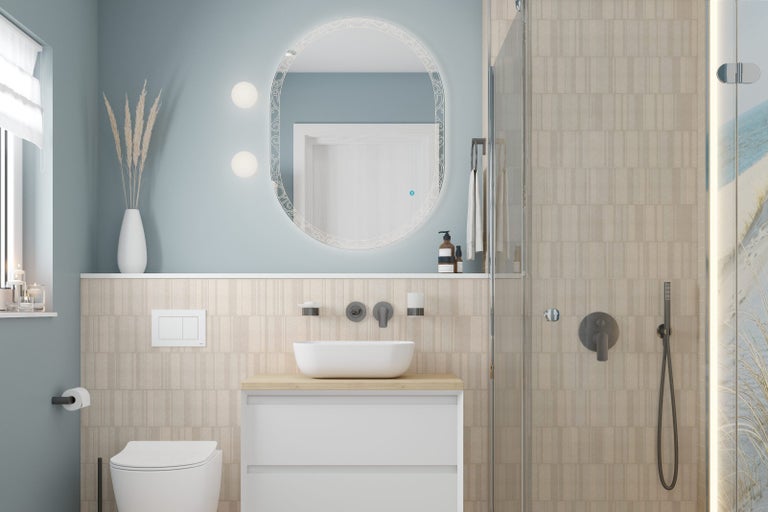 Moderní koupelna s oválným zrcadlem, umyvadlem na desku, toaletou a sprchou