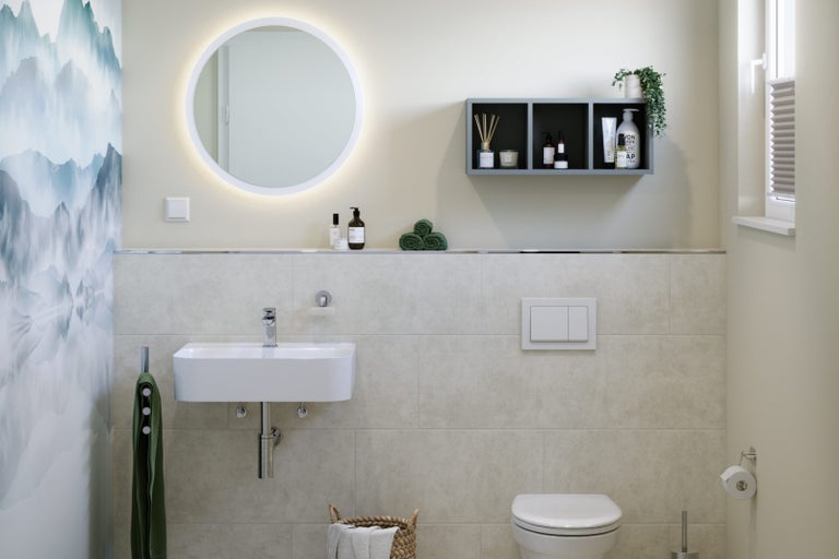 Moderní koupelna s kulatým zrcadlem, umyvadlem, toaletou a úložnými prostory.