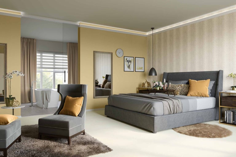 Světlá ložnice s postelí, křeslem a přilehlou koupelnou