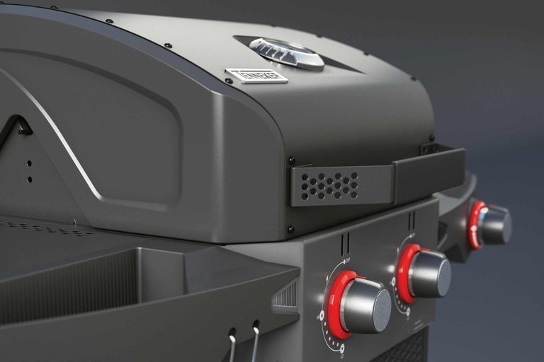 Detailní pohled na plynový gril s ukazatelem teploty a otočnými knoflíky