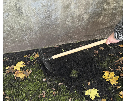 Zahradní motyka s dřevěnou rukojetí používaná k prokypřování půdy