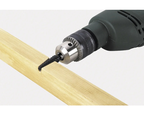 Elektrická vrtačka s namontovaným kartáčem na kusu dřeva