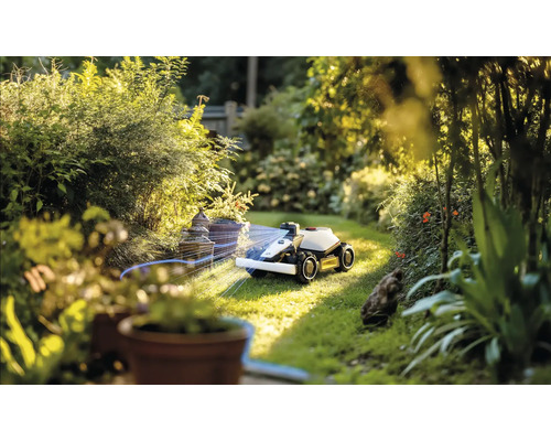 Robotická sekačka v provozu v zelené zahradě