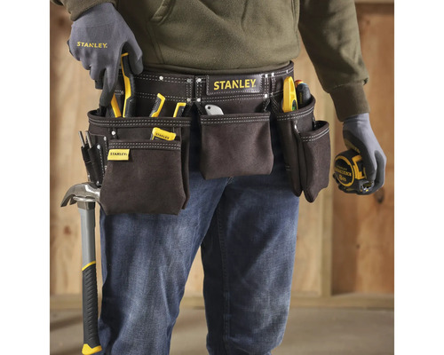 Řemeslník s pásem na nářadí značky Stanley, vybavený různým nářadím