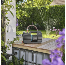 Zahradní čerpadlo Gardena na dřevěné konstrukci se zahradou v pozadí.