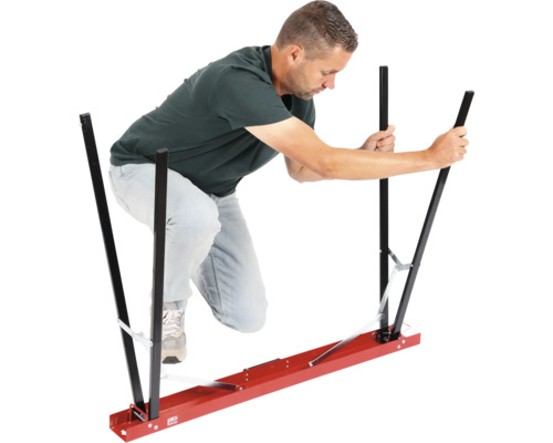 Muž obsluhuje nosnou pomůcku pro sádrokartonové desky