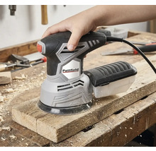 Ruka ovládá excentrickou brusku Pattfield na dřevěné desce.