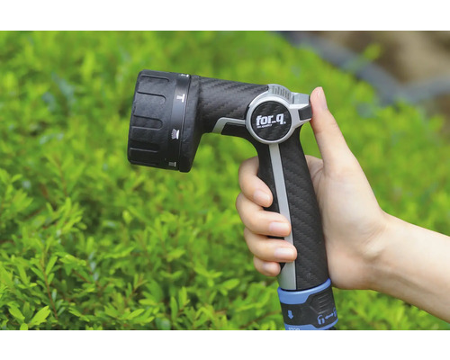 Ruka drží zahradní postřikovač značky for_q.