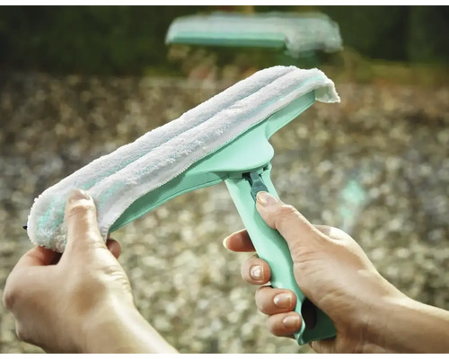 Stěrka na okna s návlekem z mikrovlákna držená v ruce