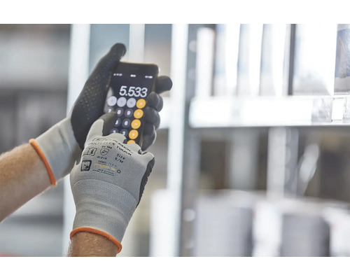 Osoba v pracovních rukavicích používá kalkulačku na smartphonu.