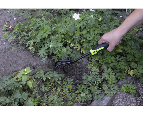 Zahradnická scéna s osobou, která používá kultivátor značky for_q k úpravě půdy.