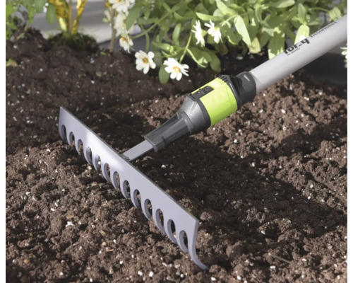 Zahradní hrabě For_q se spojkou Fitconnect na tmavé hlíně ve světlém, udržovaném záhonu.