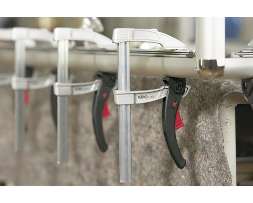 Několik rychloupínacích svorek KliKlamp připevněných k trubce.