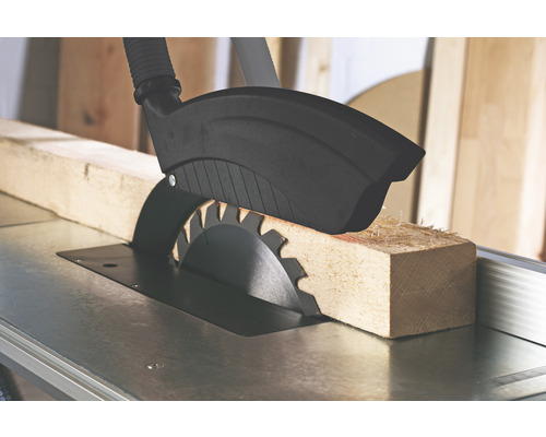 Stolní kotoučová pila při řezání kusu dřeva.