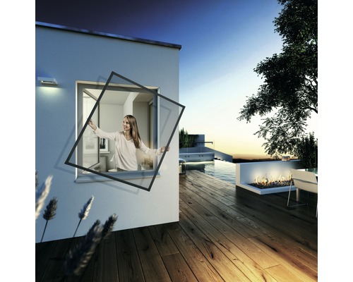 Žena instaluje do okna domu s terasou a bazénem síť proti hmyzu.