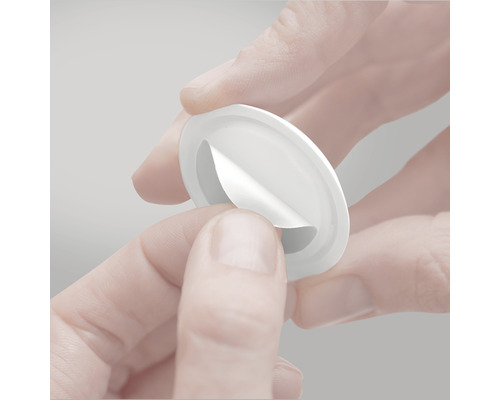 V ruce držený kulatý odnímatelný lepicí podložka.