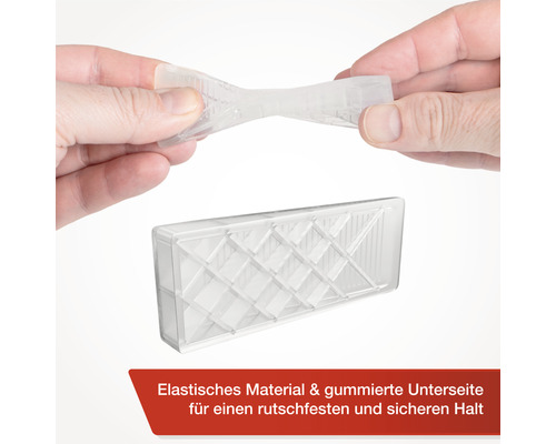 Průhledný dveřní zarážka z elastického materiálu drží v rukou