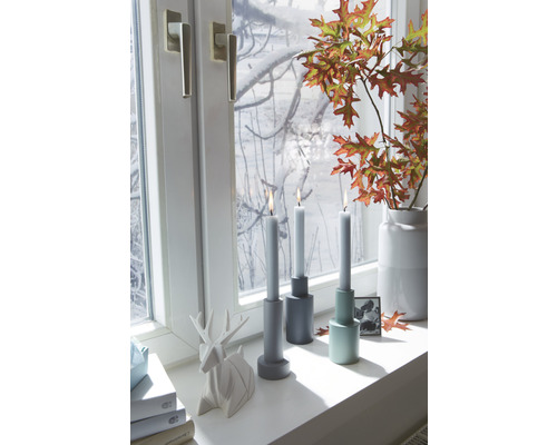 Dekorativní scéna se svícny, svíčkami, oknem, figurkou jelena a podzimním listím