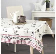 Stůl s ubrusem s motivy kuřat a bordurou se vzorem kohoutí stopy.