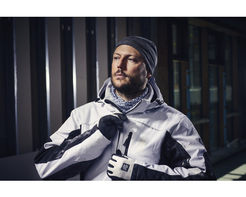 Muž s čepicí, rukavicemi a pracovní bundou