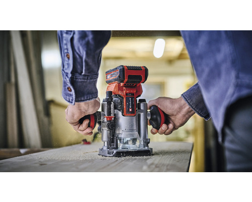 Jednoruční frézka používaná na dřevěné desce.