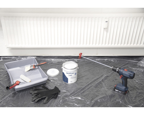 Scéna s lakem na radiátory, vaničkou na barvu, štětcem, válečkem na barvu, akumulátorovým šroubovákem a ochrannými rukavicemi pro lakování radiátoru