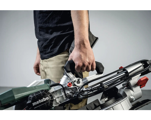Osoba drží v ruce pokosovou pilu Metabo.