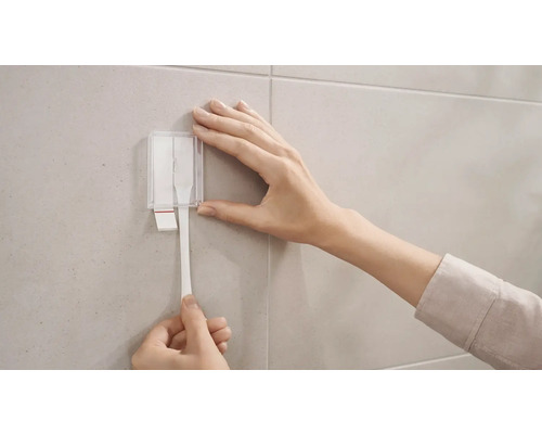 Upevnění lepicího proužku na nástěnný držák