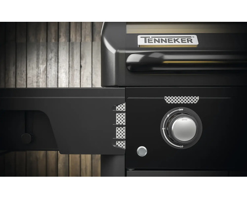 Detail plynového grilu Tenneker s bočním stolem a otočným knoflíkem pro regulaci teploty.