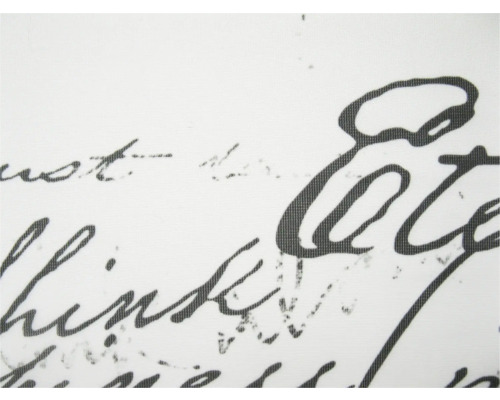 Detailní záběr bílé látky s černým písmem