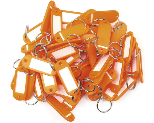 Hromada oranžových klíčenek s popisovacím polem a kroužkem na klíče