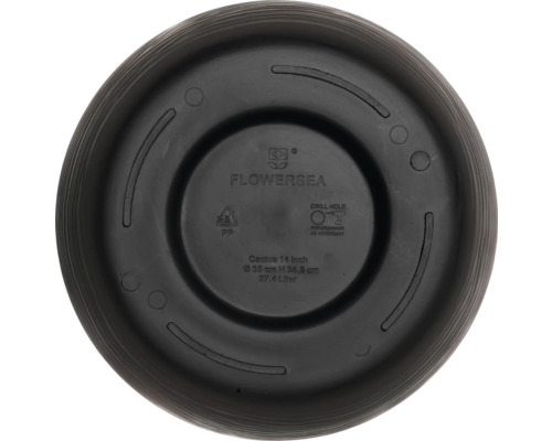 Spodní strana květináče s informacemi od výrobce a návodem k vrtání