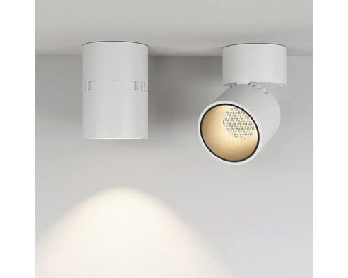 Dva bílé stropní reflektory, jeden z nich otočný