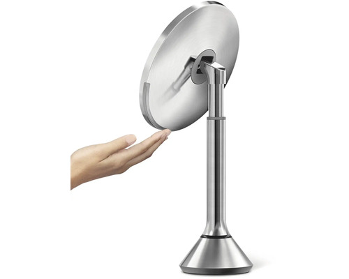 Volně stojící kosmetické zrcadlo z kovu s rukou na obrázku