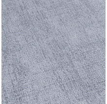 Detail světlé, strukturované textilie.