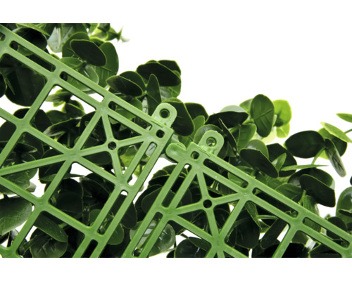 Detailní záběr zelené rostlinné rohože s plastovou mřížkou