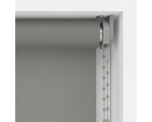 Šedá roleta s řetízkovým ovládáním v okenním rámu.