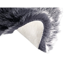 Šedý koberec z umělé kožešiny se zahnutým rohem