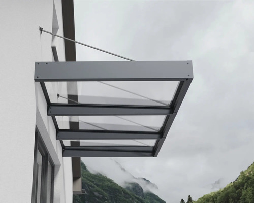 Moderní prosklená stříška s antracitovým hliníkovým rámem, namontovaná na venkovní stěně pomocí táhel.