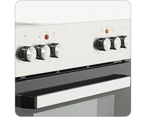 Detailní pohled na stříbrný sporák s otočnými knoflíky