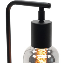 Stolní lampa se žárovkou a černým rámem