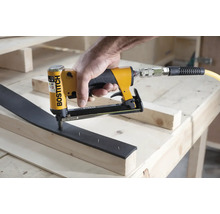 Logo společnosti Bostitch na pneumatické hřebíkovačce používané na dřevěném trámu