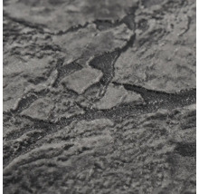 Strukturovaný povrch vliesové tapety s kamenným vzhledem.